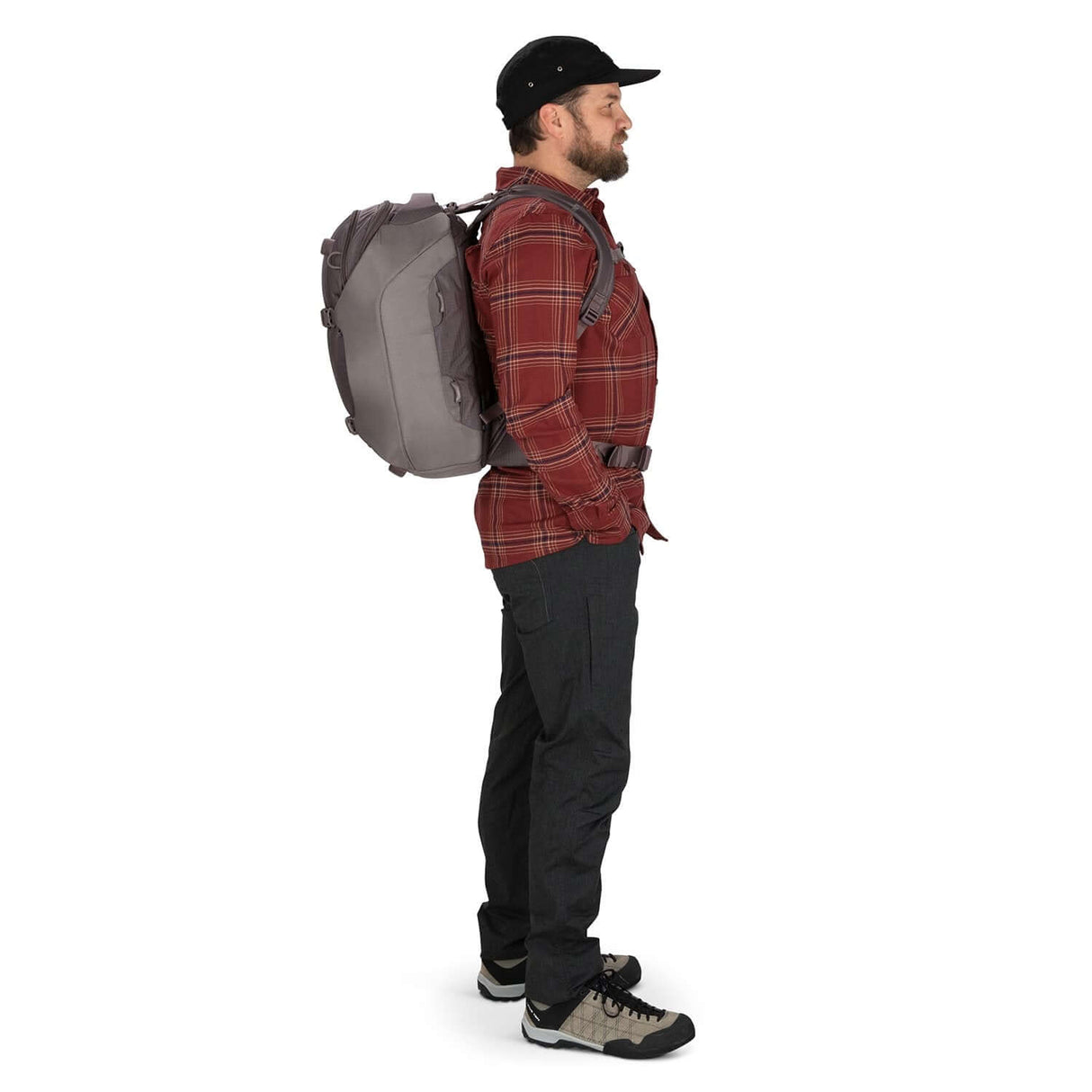 Side view of a man wearing the Osprey Sojourn Porter 30L Travel Backpack, demonstrating its sleek design and comfort for travel.