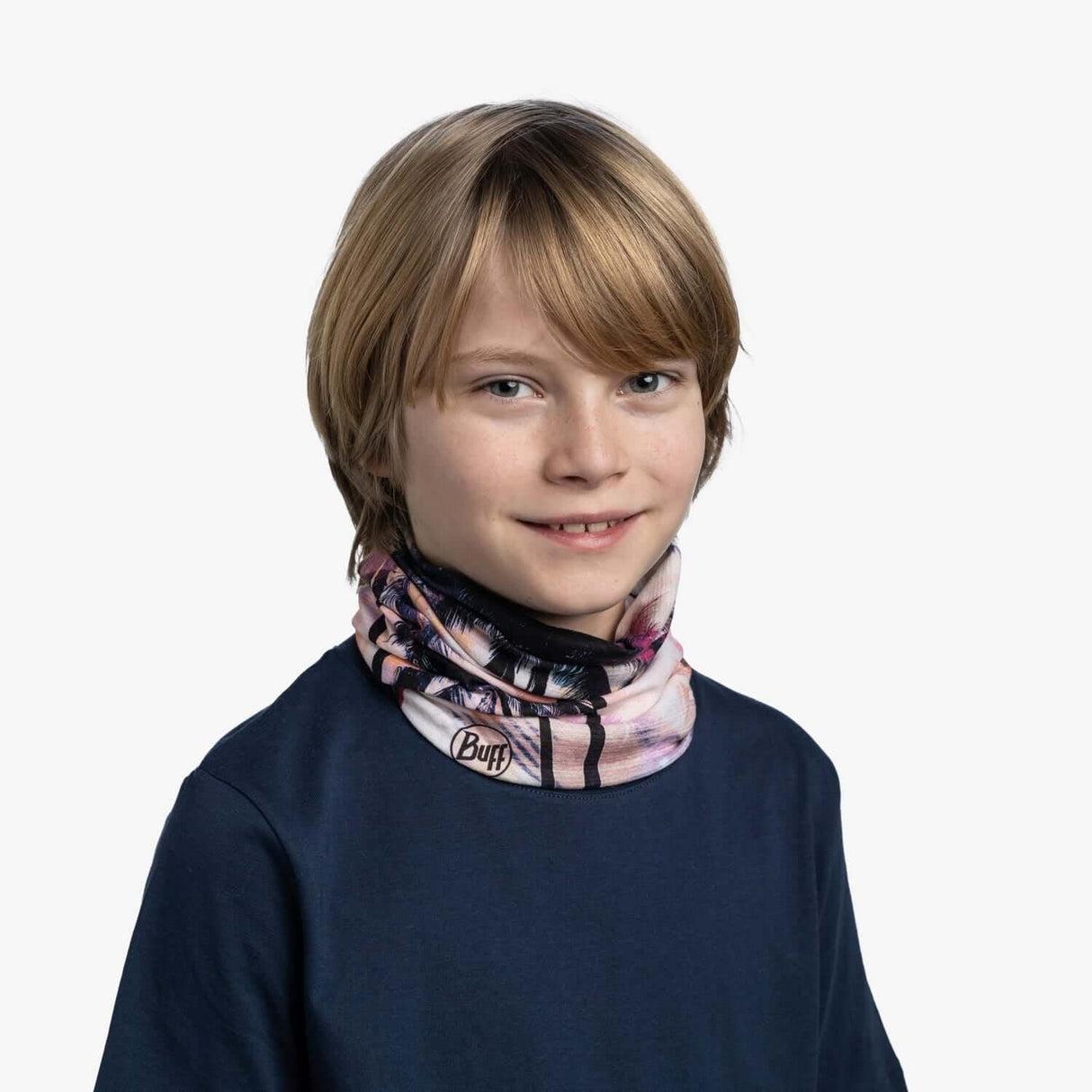 Child wearing Buff CoolNet UV Neckwear Youth - Coasty Multi, designed for sun protection and active play.