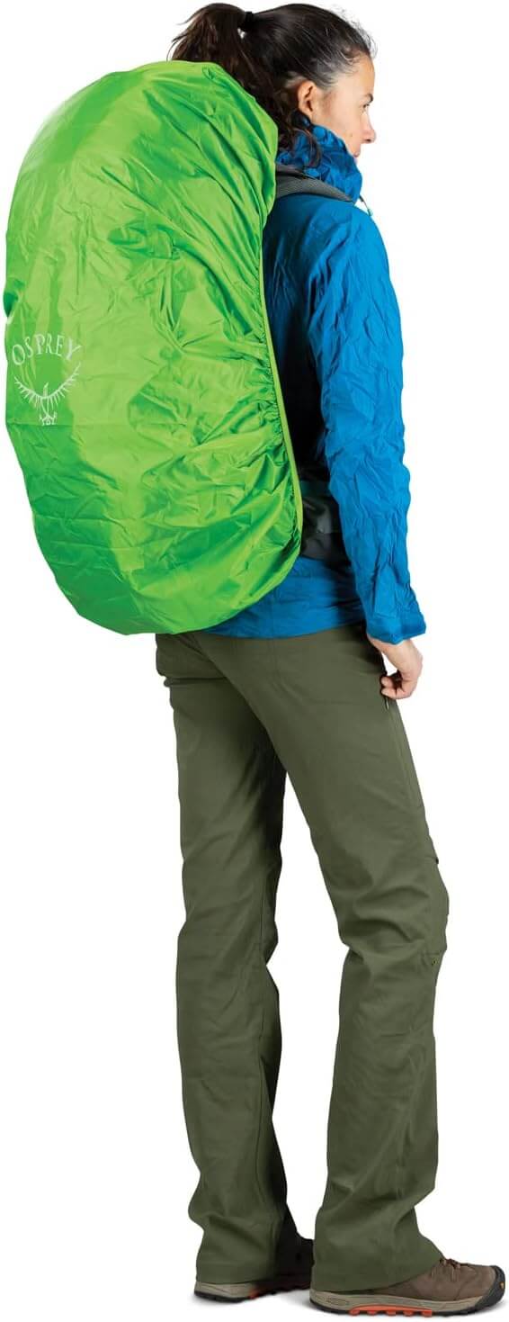 Woman wearing Osprey Renn 50L backpack with raincover, designed for women's fit, featuring torso adjustment, by Osprey.