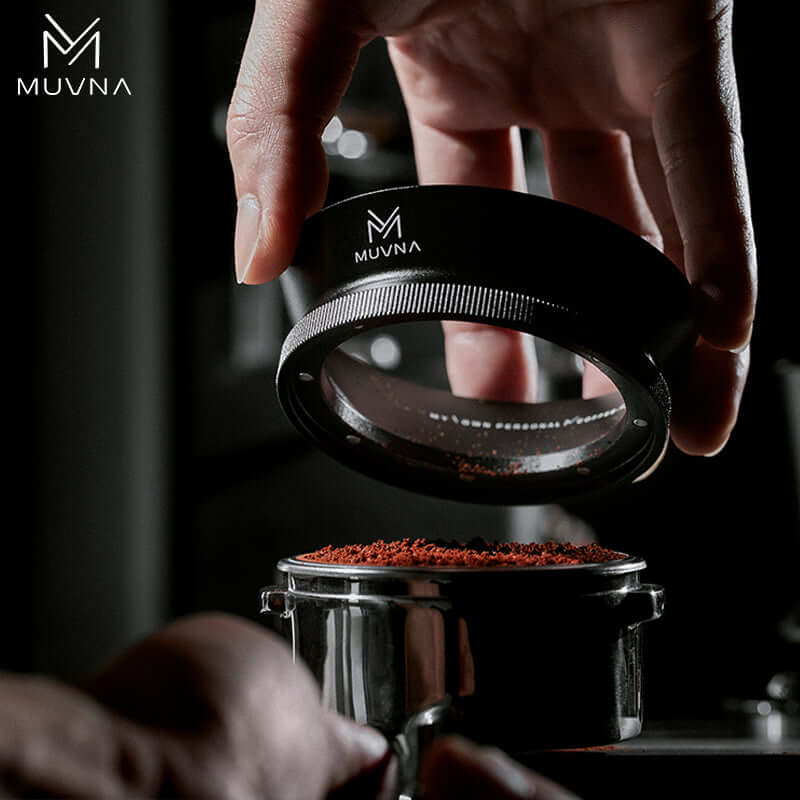 Muvna Espresso Magnetic Dosing Funnel being used to pour coffee grounds into a portafilter.