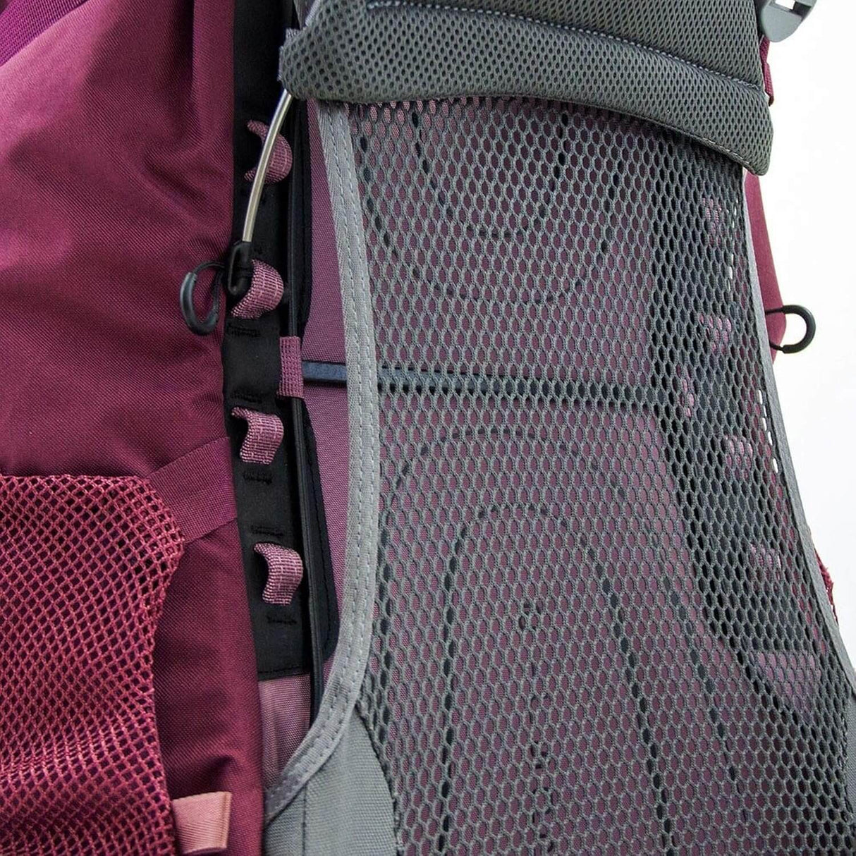 Side view of Osprey Renn 50L - Women backpack with mesh panel and ladder lock torso adjustment detail.
