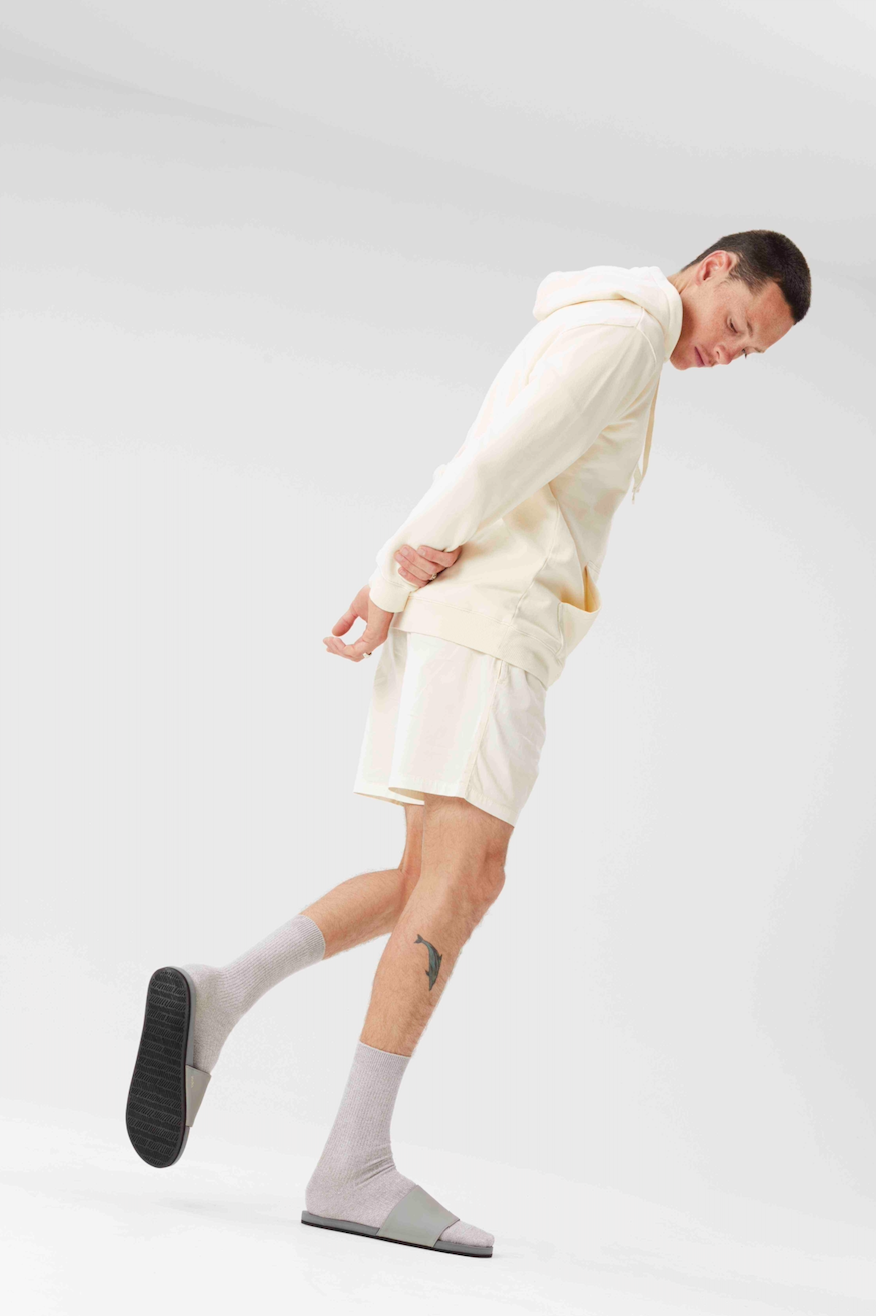 Man wearing Indosole Slides with recycled tire sole, showcasing sustainable men's footwear.