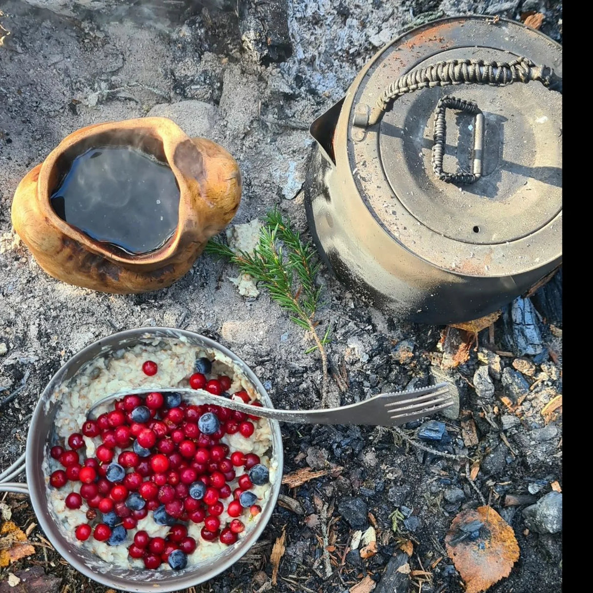 Camping breakfast with SilverAnt Titanium Spork 3-In-1 Knife Fork Spoon, kettle, and wooden cup by the fire