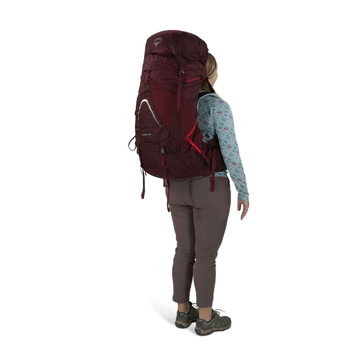 Woman wearing Osprey Aura AG LT 65 backpack for women, showcasing lightweight design and comfort for backcountry adventures.