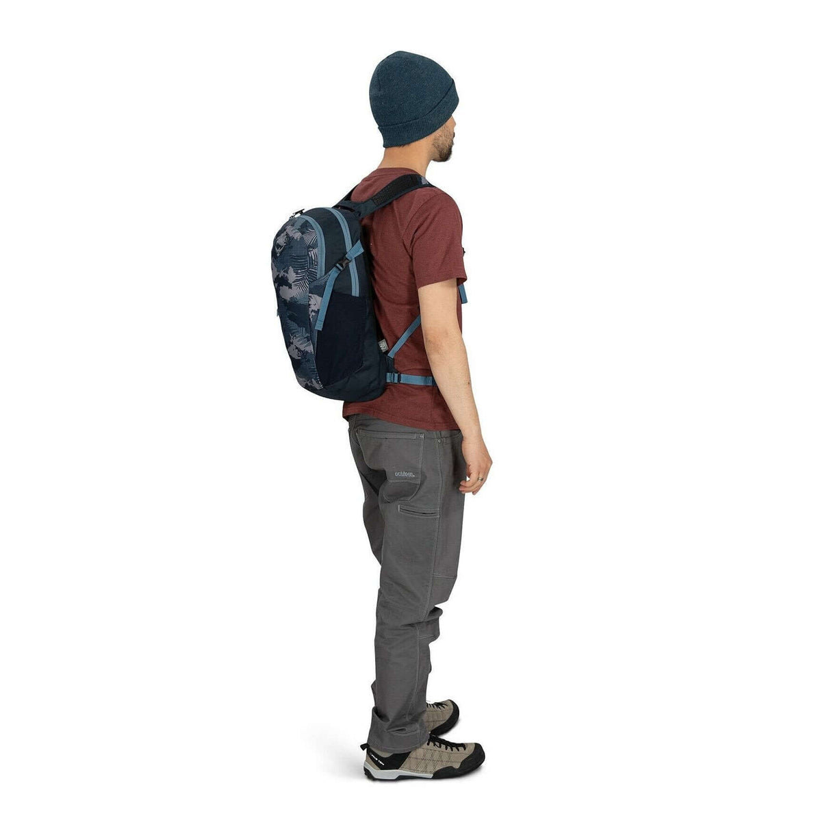 Side view of a person wearing the Osprey Daylite backpack in a casual outfit, showcasing its versatility and lightweight design.