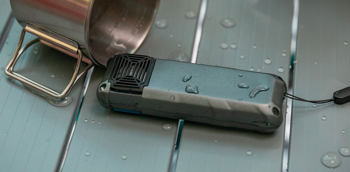 Flextail Max Repeller S — USB-C charging cable connected on a tabletop.