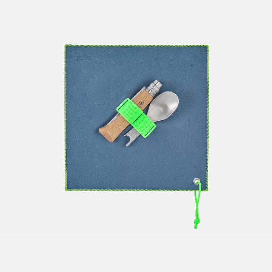 Opinel Complete Picnic + Set featuring No. 08 folding knife and accessories on a green mat by designer Franck Fontana.