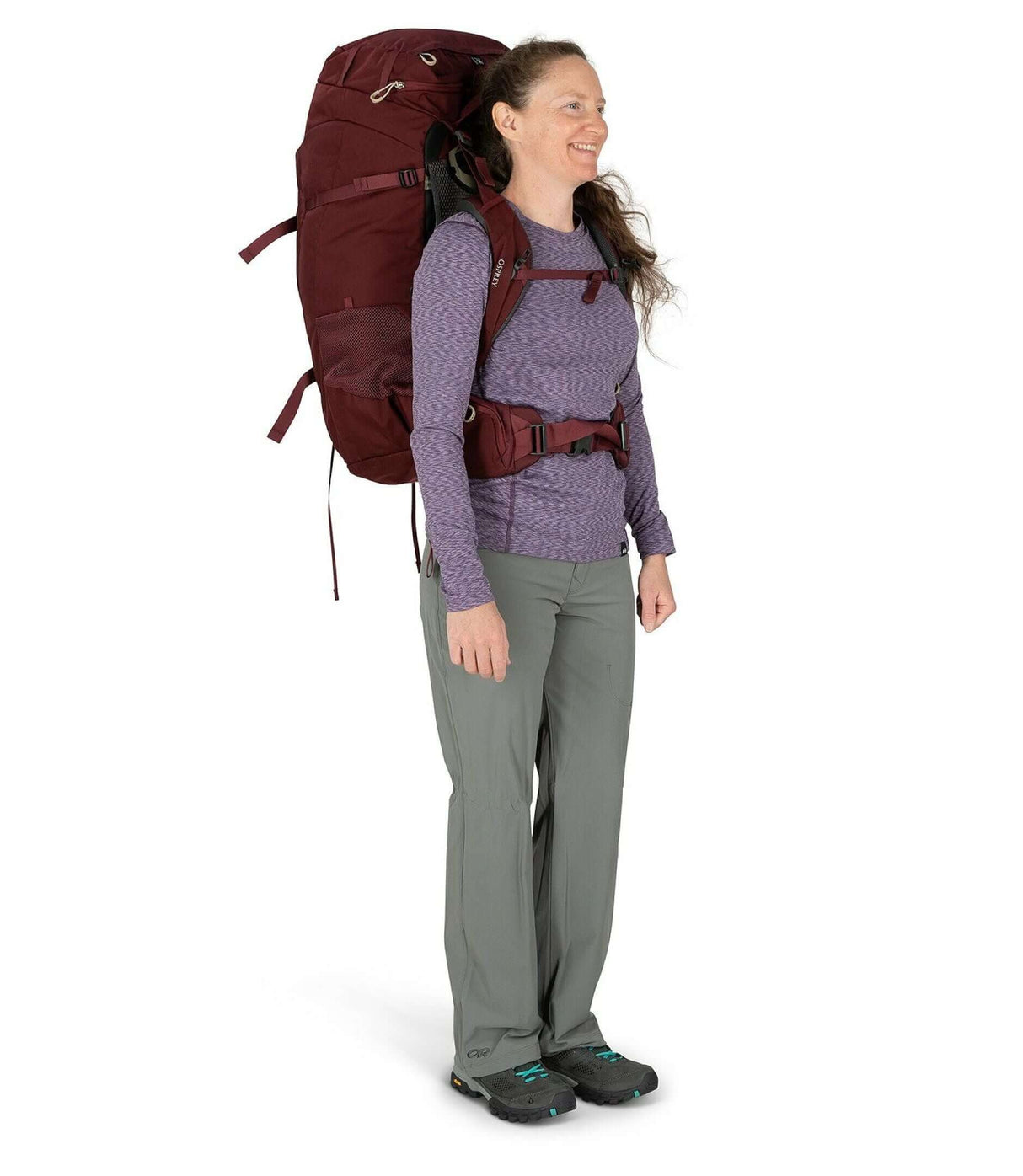 Woman wearing Fairview Trek 70 - Women backpack in a burgundy color, ready for adventure.