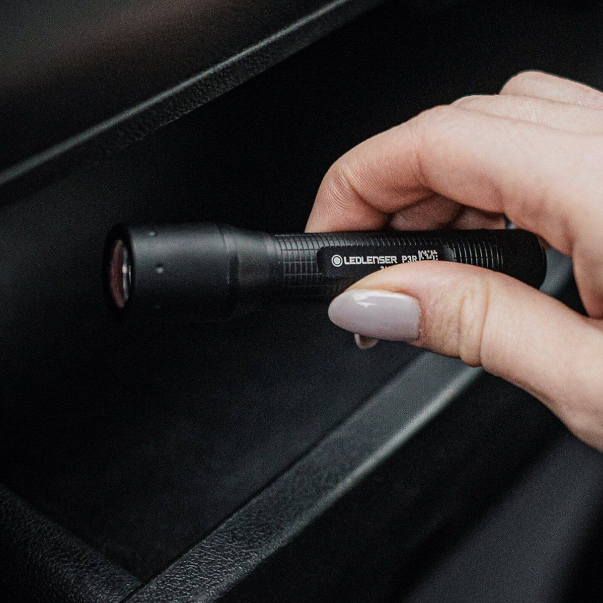 Hand holding the P3R key flashlight, showing its compact design for everyday carry.