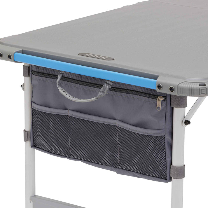Core Equipment 4 Foot Outdoor Table with FlexRail — accessories organized along the rail during outdoor cooking.