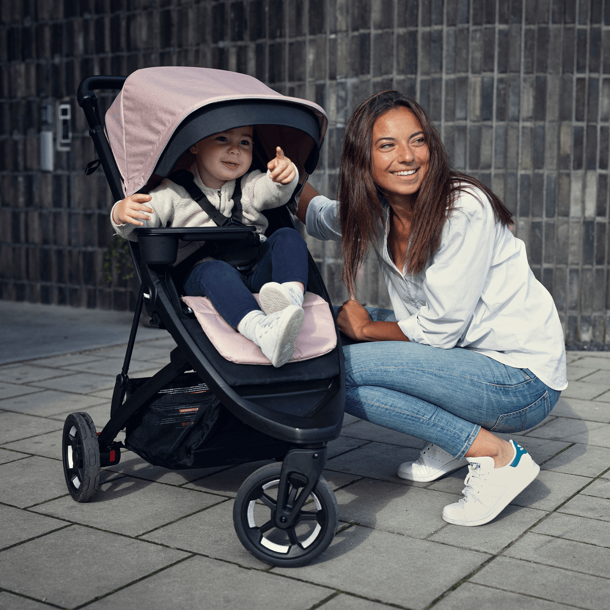 Thule Spring Canopy - Gray Melange stroller shown with vented, extendable canopy featuring UPF 50+ protection for sunny days.