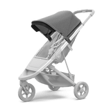 Thule Spring Canopy - Gray Melange on stroller, offering vented mesh, peekaboo feature, and UPF 50+ protection from low sun.