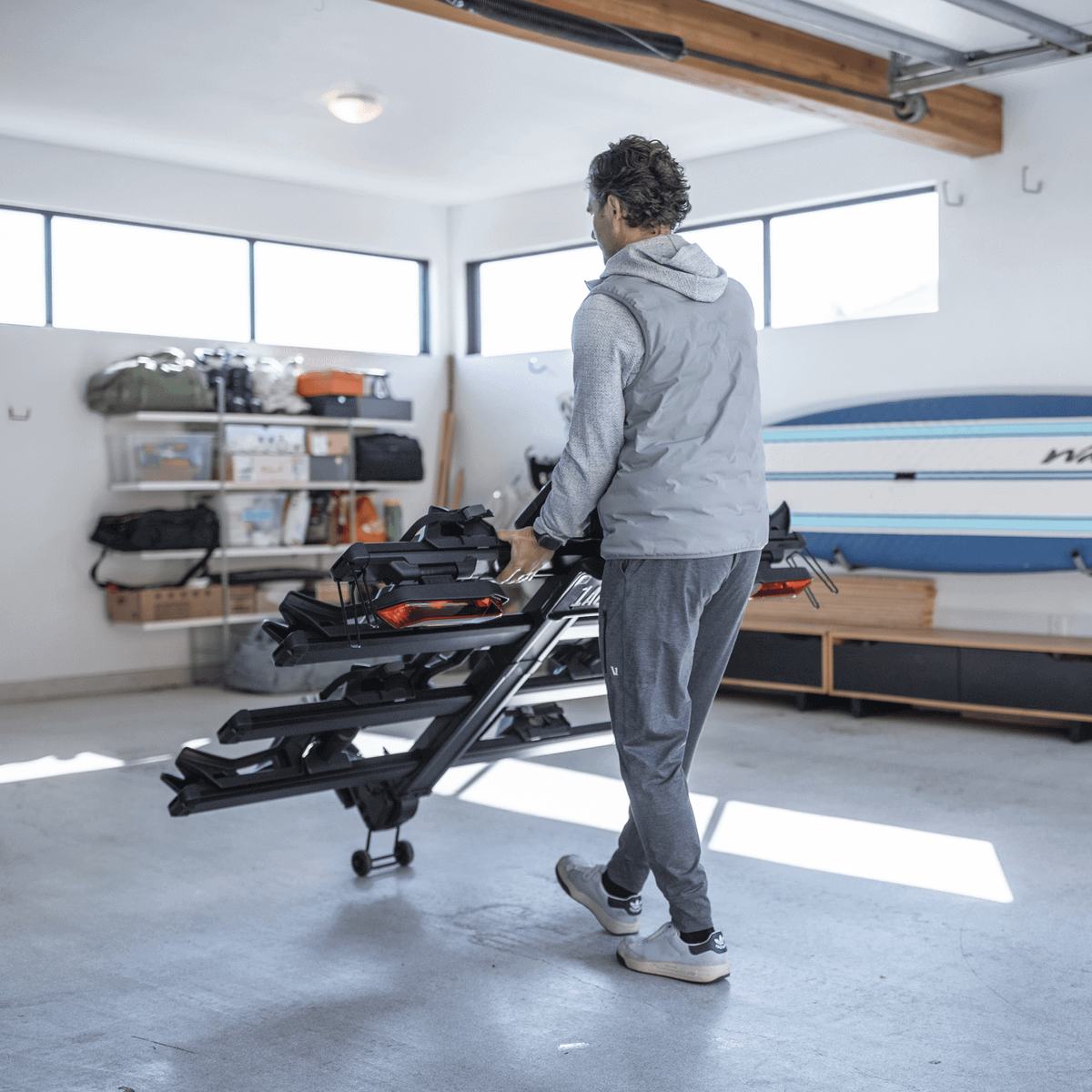 Man installing Thule Verse add-on - 2 Bike accessory on platform hitch rack in garage