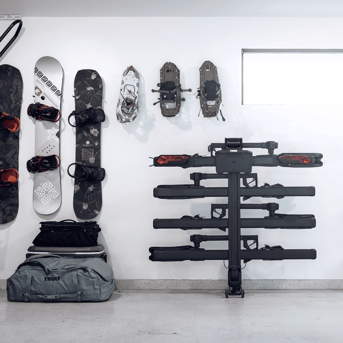 Thule Verse add-on - 2 Bike accessory on wall, enhancing Thule hitch rack to 4 bikes, suitable for 2" receivers in a garage setting.