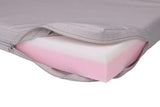 Close-up view of a mattress with a pink foam layer inside a gray cover, partially unzipped to reveal the foam.