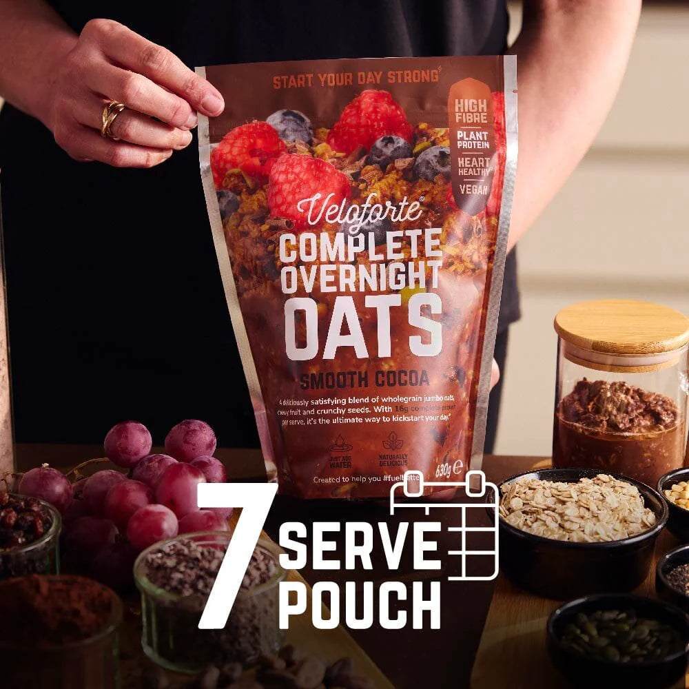 Veloforte Smooth Cocoa Complete Overnight Oats - 630g 7 serve pouch with nutritious ingredients on a breakfast table.
