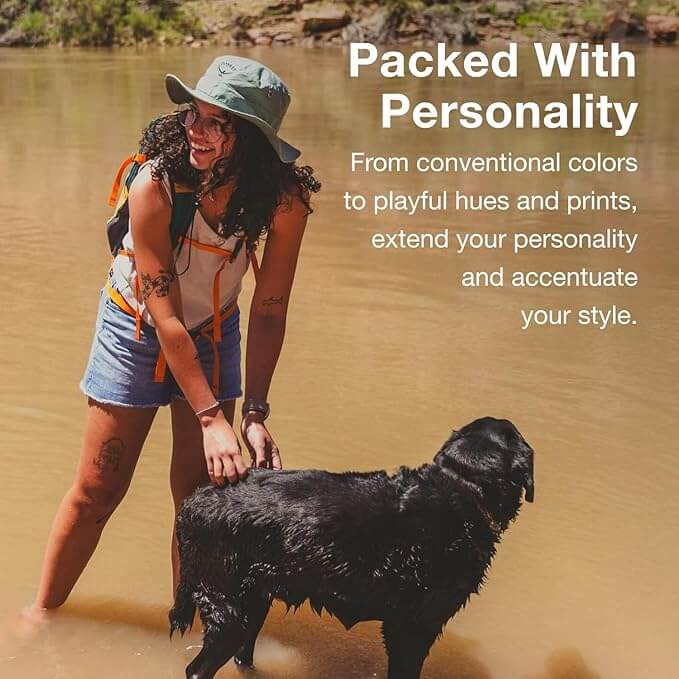 Woman with a dog wearing outdoor gear, showcasing personality and style with Osprey Daylite backpack in nature setting.