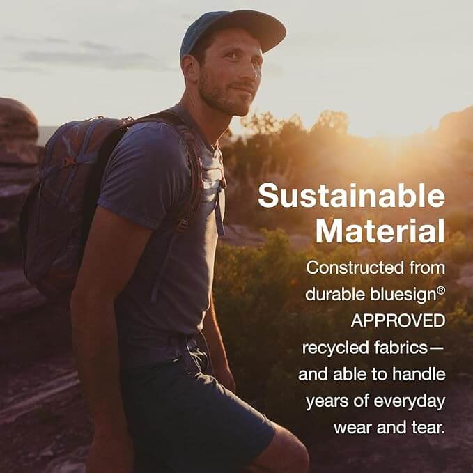 Hiker wearing Osprey Daylite backpack made from sustainable materials, featuring durable bluesign® approved recycled fabrics.
