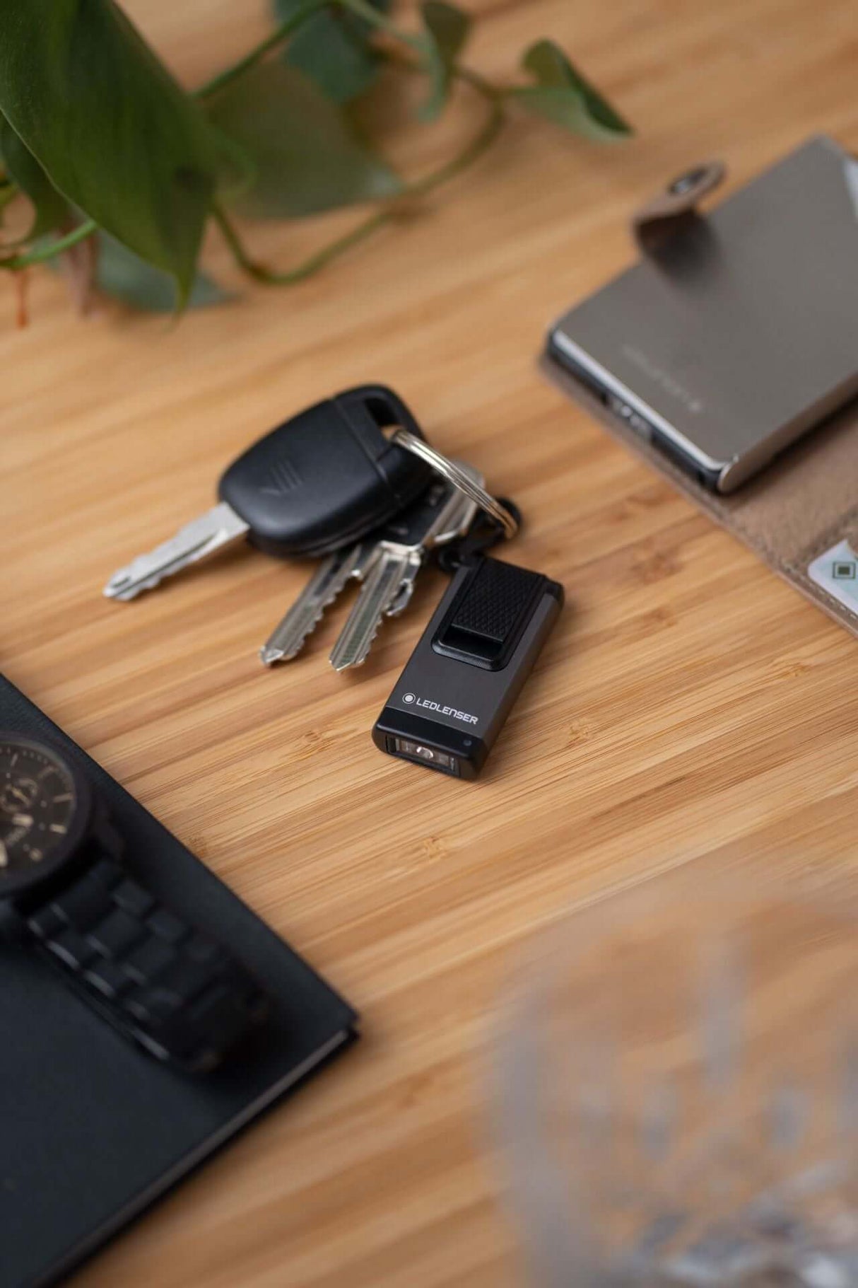 Ledlenser Flashlight K4R rechargeable keychain light on wooden table with keys