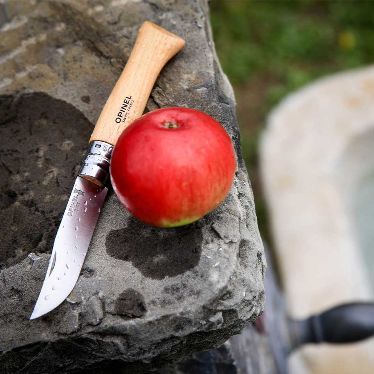 Opinel Traditional Stainless Steel Knife with red apple on stone