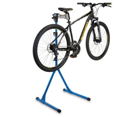 Park Tool Deluxe Home Mechanic Repair Stand - PCS-4-1 holding a mountain bike in a workshop setting
