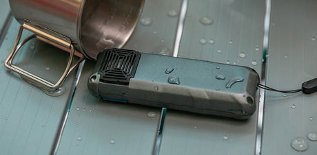 Flextail Max Repeller S — USB-C charging cable connected on a tabletop.