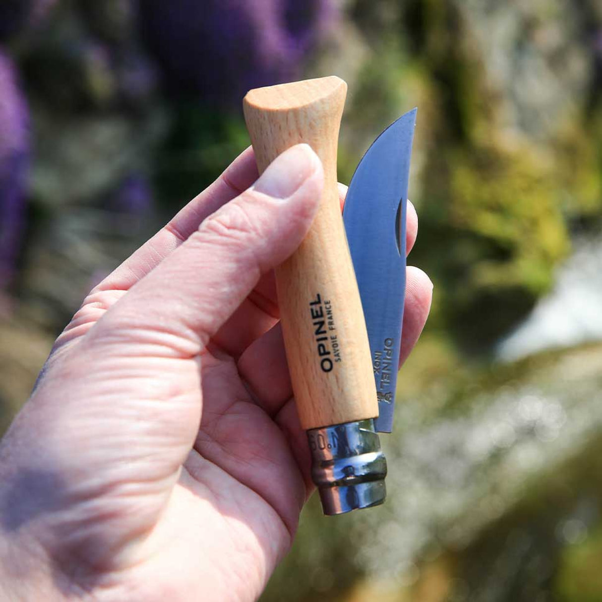 Opinel Traditional Stainless Steel Knife N°06 with Virobloc safety held outdoors.