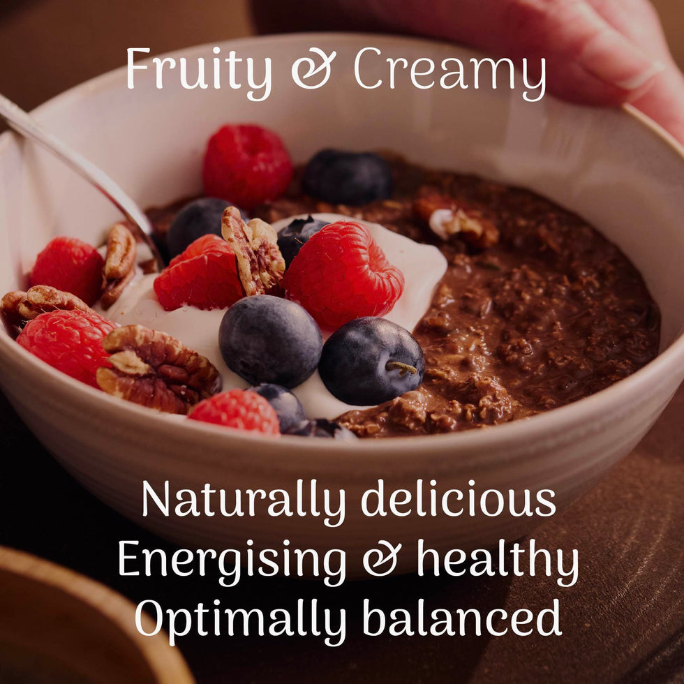 Veloforte Smooth Cocoa Complete Overnight Oats - 630g served with berries and yogurt in a bowl.